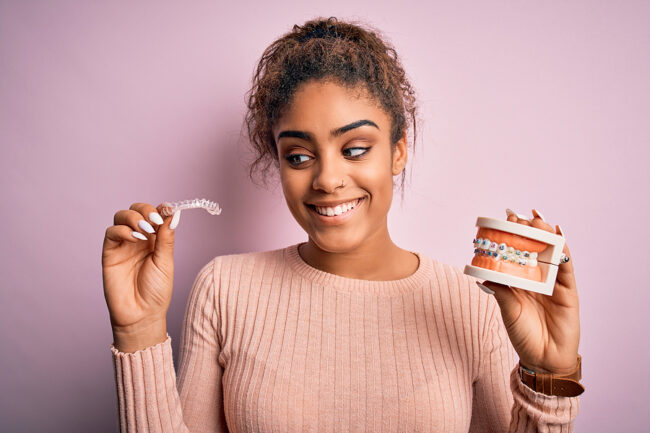 Young african american woman smiling happy holding professional