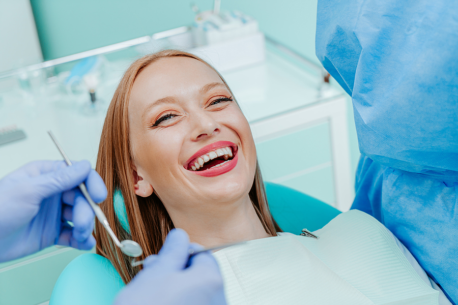 Attractive Young Woman Smilling With Natural White Teeth In Dent